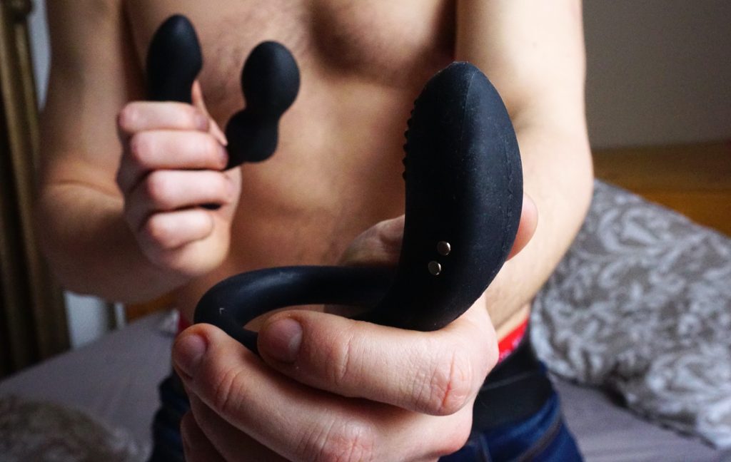 man holding anal prostate massagers