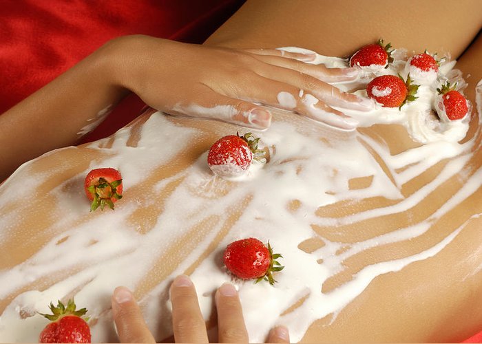 nude women covered by whipped cream and strawberries